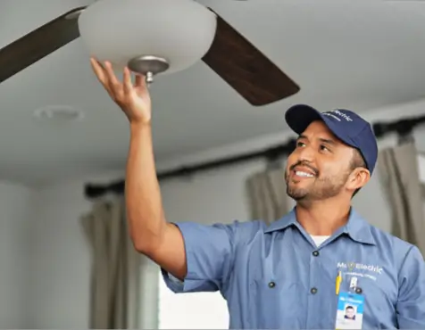 Mr. Electric technician installing a ceiling fan.