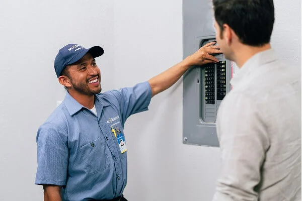 Mr. Electric electrician explaining the electrical panel repair process to customer