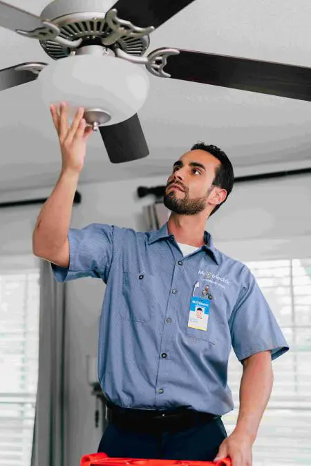 Mr. Electric electrician performing a ceiling fan installation service
