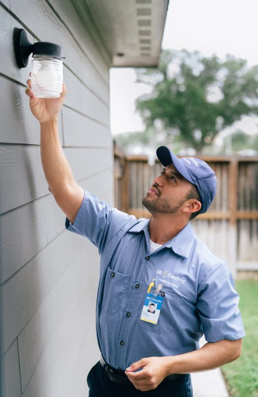 Mr. Electric electrician installing an outdoor light.
