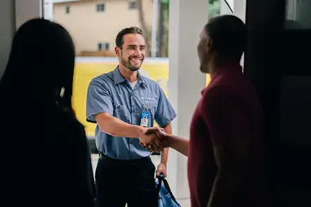 MRE electrician shakes hands with customer.