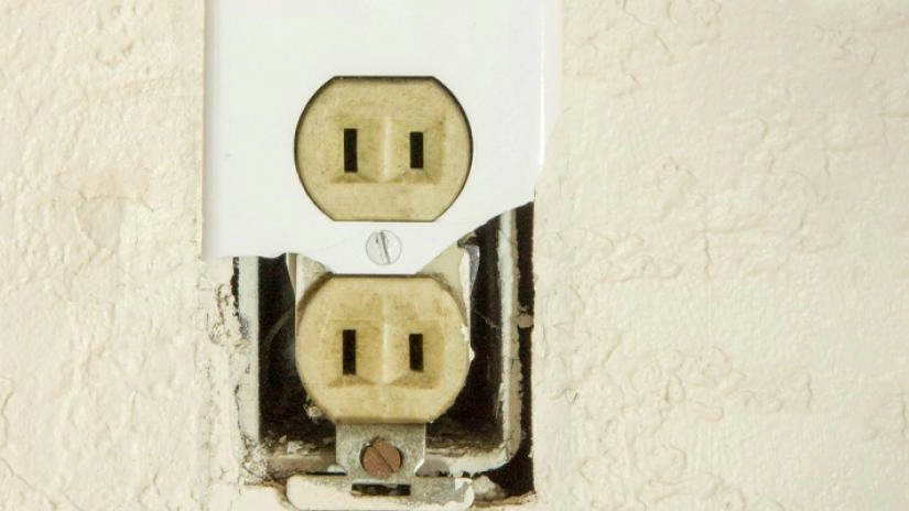 Two-prong outlet with broken cover.